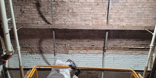Workers performing restoration at Soho-Cast Iron District